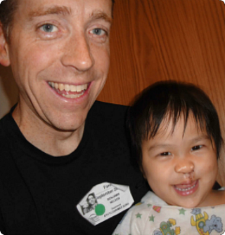 Veronica and her dad, Ben, after surgery on her cleft lip, palate, and ear tubes.