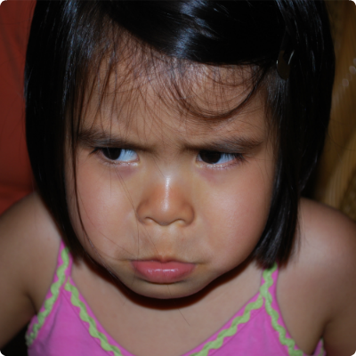A young girl from China pouts.