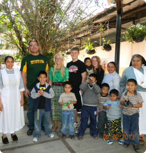 Brianne and her family while volunteering at Hogar del Nino.