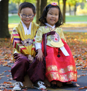 Adopted siblings in traditional Korean clothing.