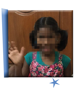 B, an adorable little girl who currently waits in South Asia, waves at the camera.