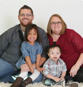 A family picture of Ted, his wife, and his son and daughter who both have Down syndrome.