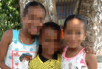 A blurred photo of these three siblings, waiting in Latin America for an adoptive family.