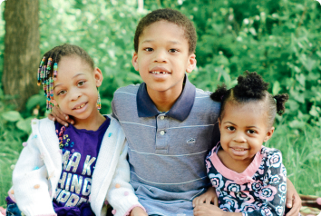 A picture of Emmanuel, Angelina and Maria, three siblings waiting for adoption in Minnesota foster care.