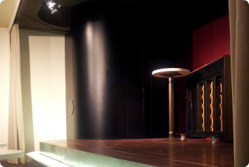An empty stool on a stage for auditions to perform in a play about adoption. Photo via Flickr Eyebidem.