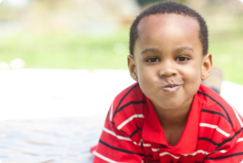 A young black boy makes a funny face in recognition that uncertainty is the only adoption certainty.