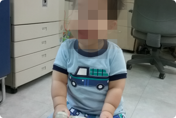 A blurred picture of JW, a toddler waiting in Asia, to protect his privacy.