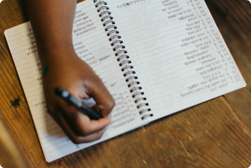 A picture of an adoptee's hand as she writes a list of what adoptive parents could do differently or better.