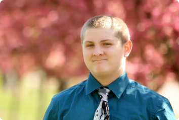 Tyler is pictured in a park. He is a young teen waiting for an adoptive family in Minnesota foster care.