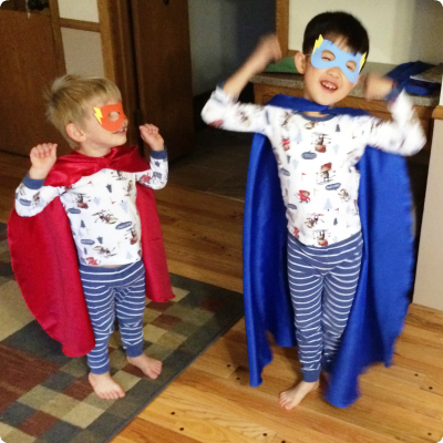 Brothers, one adopted from China, in super hero costumes.