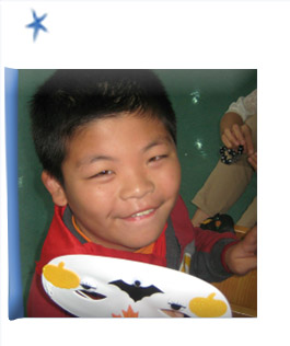 The first door in the advent calendar is opened to show YF's photo. A boy waiting for an adoptive family in Asia.