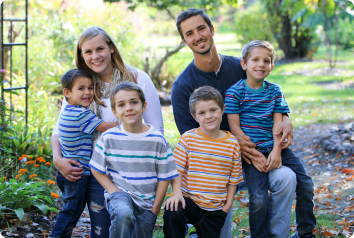 Brooke and Brandon smile with their four sons who were adopted from foster care as a sibling group.