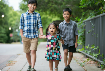 Jonah, Isaac and Chloe, all adopted from Korea, walk hand in hand.