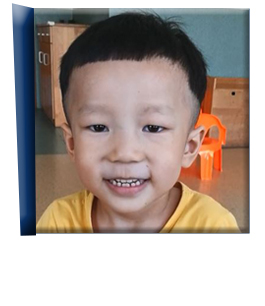 The fourth door opens to reveal a young boy in Asia who waits for adoption. He's smiling and wearing a yellow shirt.