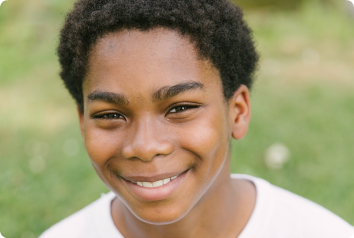 Dayshawn smiles softly at the camera. He waits in foster care for an adoptive family.