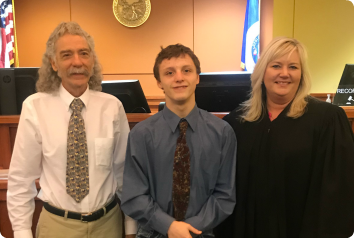 Jeff, Dakota and their judge on their adoption day.