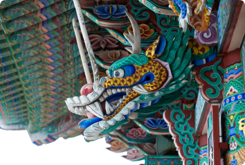A close up of an ornate dragon that is part of a building in South Korea.