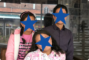 Three siblings in Latin America who wait for adoption. Their faces are covered to censor their identities.