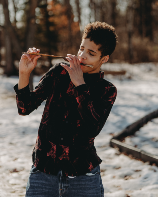 Fourteen year old boy outside in winter wearing plaid shirt