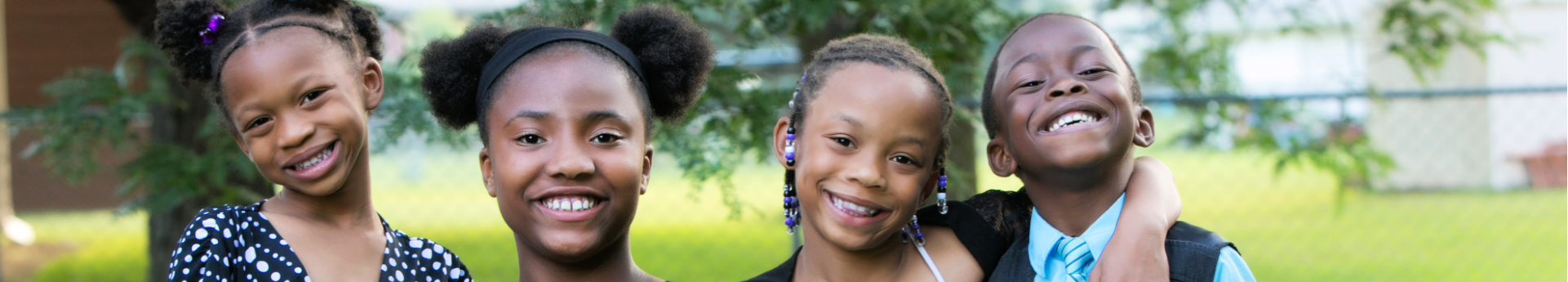 four african-american siblings smile