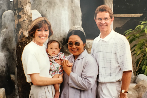 Two white adoptive parents with adopted Asian daughter and Asian woman