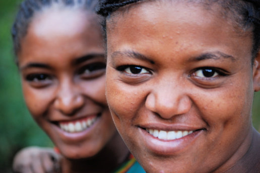 Two ethiopian women face camera smiling
