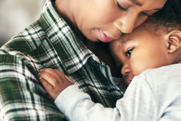 Black mother and infant embrace