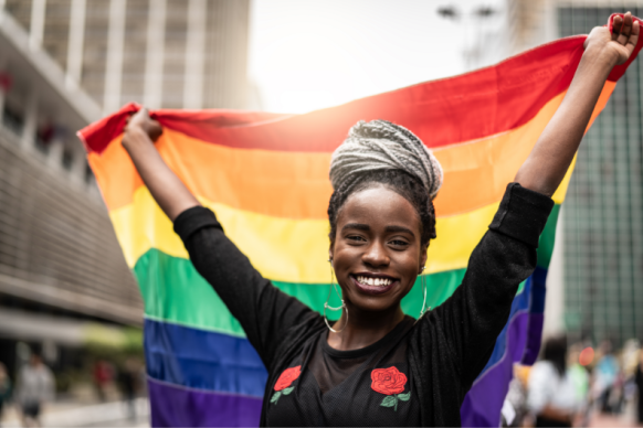 African American female smiles with pride flag
