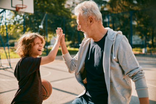 Grandfather and grandson play basketball