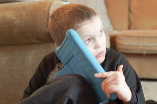 Young boy plays with tablet