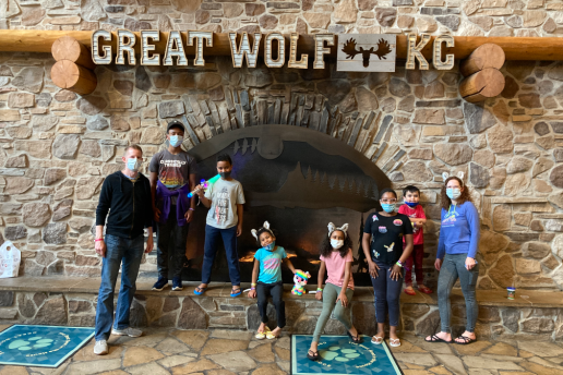 Family of eight smiles on summer vacation together and Great Wolf Lodge