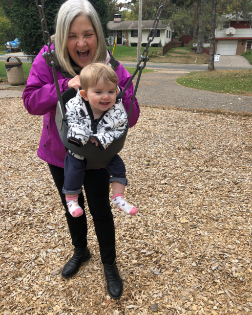 Happy grandmother with granddaughter at park