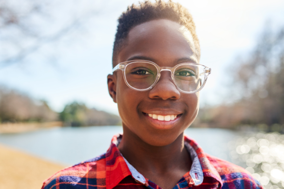 Young teen smiles with glasses