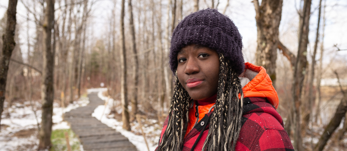 Black teen female in purple winter hat