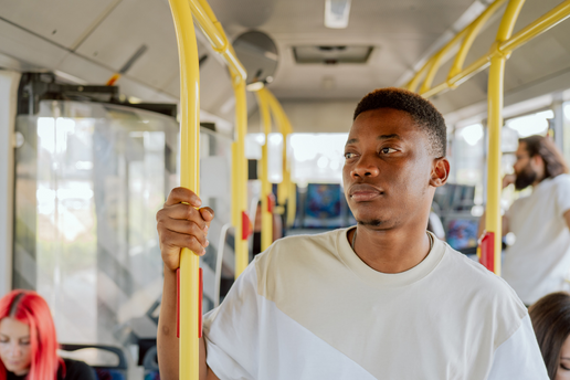 Teen boy rides public transport alone.