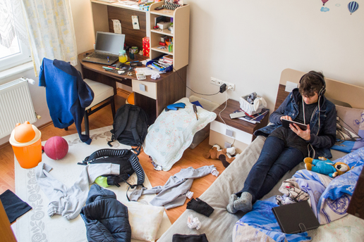 Teen in disorganized room
