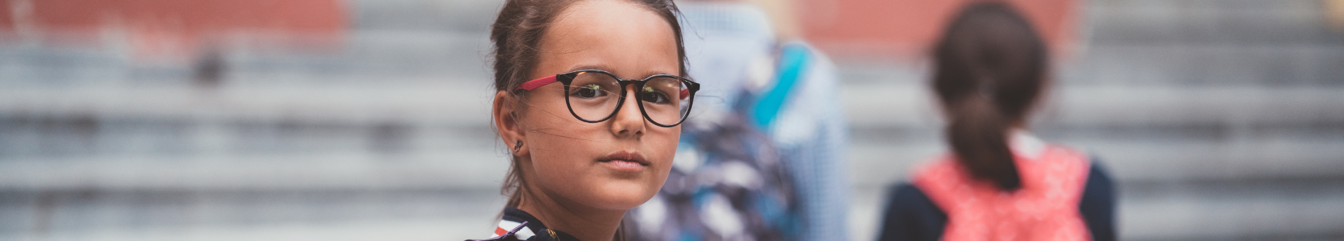 Girl with glasses outside of school