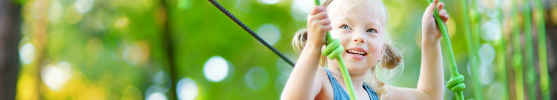 Young girl smiles at ropes course