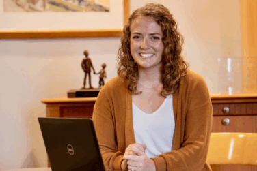Lyla Ronchak, a child specific recruiter at Children's Home, sitting at her laptop