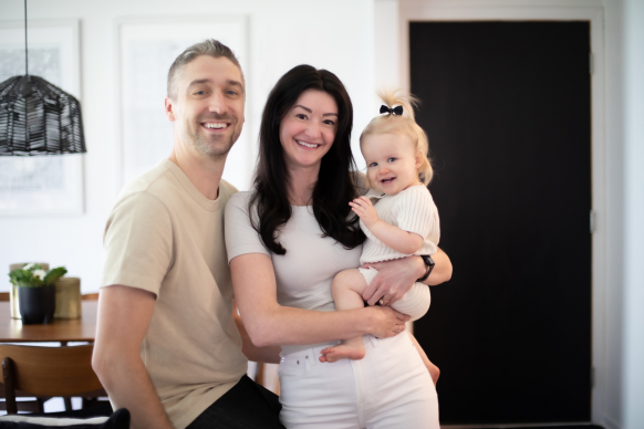 Melissa Moran and Cory Dammann with their daughter Weslie in their home