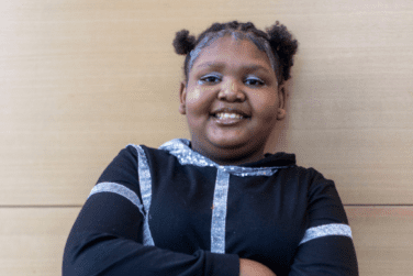 Evie, a youth experiencing foster care who is waiting to be adopted.