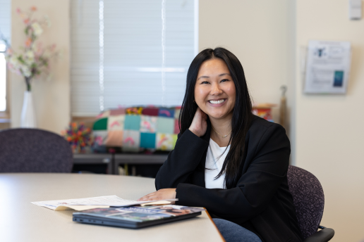 Child specific recruiter Colleen smiling and sitting at a desk