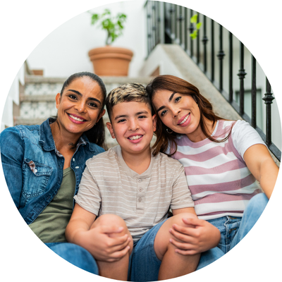 two women and a young boy sitting on stairs