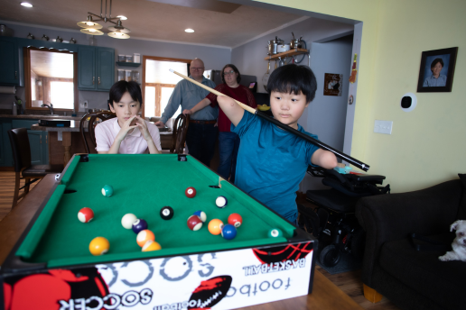 Jiangli and family playing pool