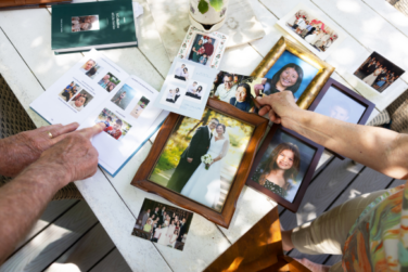 hands holding a collection of family photos